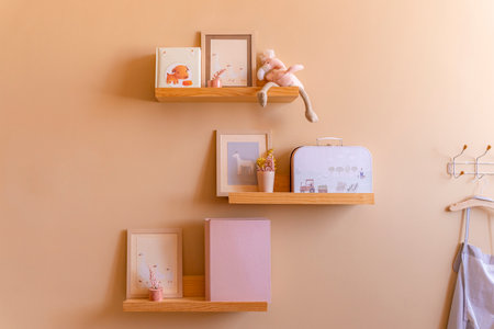 Kids room decor, wooden floating shelves interior child bedroom, empty wooden picture frame, books,...