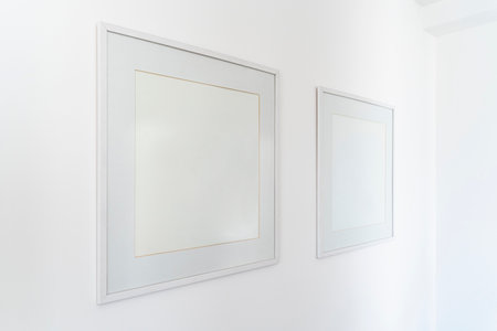 Empty square white frame, poster white canvas mock up on a white wall, living room, template angle view gallery, home decorationの写真素材