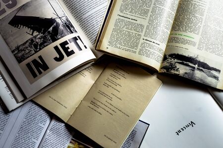 A bunch of books in different formats and colors in overhead shotの写真素材