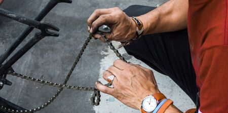 Mechanic Dirty hands fixing a bicycles chainの写真素材