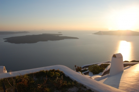 Sunset over islands in Santoriniの写真素材