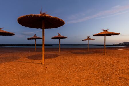 Long exposure night photo of beach umbrellasの写真素材