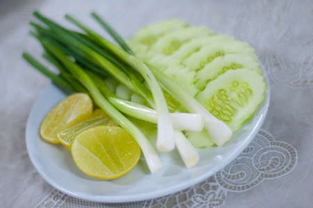 Green spring onion, sliced cucumber and lime, Vegetable side dish の写真素材