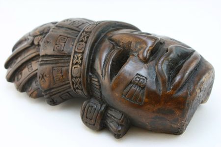 Mayan carved dark mask, isolated on white