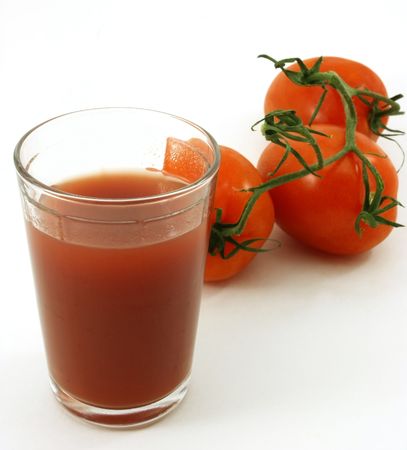 Tomato juice and tomatoes in backgroundの写真素材