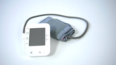Electronic blood pressure meter and cuff on white background, Medical electronic tonometer check blood pressure, Health and Medical conceptの写真素材