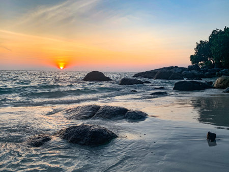A beach scene at Lipe Island, rock on beach at sunset, Satun, Thailandの写真素材
