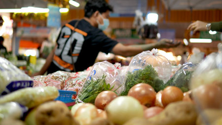 Blurred background of marketplace in Bangkok, People shopping fresh vegetables in market,  consumerism and people conceptの写真素材