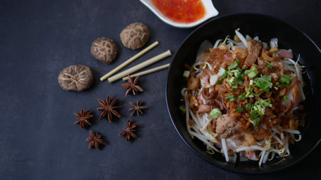 Rice flat noodle with dried shrimp,  ground pork, squid, tofu and beansprout in sweet black soy...