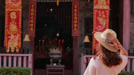 February 25 2021 - Bangkok, Thailand : Asian girl in back view standing in front of Shrine in Bangkok, Thailand.のeditorial素材