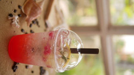 Strawberry soda in plastic cup with straw, sweet and cold drink concept.の写真素材