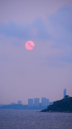 Full moon rising over sea at Pataya city Thailand.の写真素材