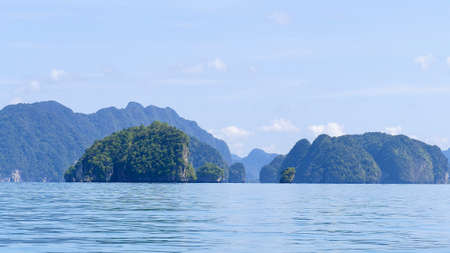 Blurred exotic scenery islands with cloudscape and calm waters of Andaman sea in Krabi Province, Thailand, Selective focus on scene.の写真素材