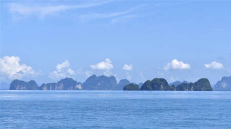 Exotic scenery islands with cloudscape and calm waters of Andaman sea in Krabi Province, Thailand, Selective focus on scene.の写真素材