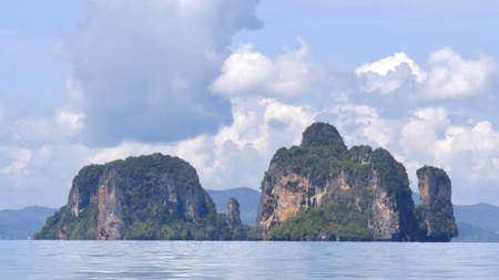 Exotic scenery islands with cloudscape and calm waters of Andaman sea in Krabi Province, Thailand, Selective focus on scene.の写真素材