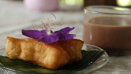 Deep-fried dough stick or Youtiao decorate with flower and hot Chocolate on the side, popular...