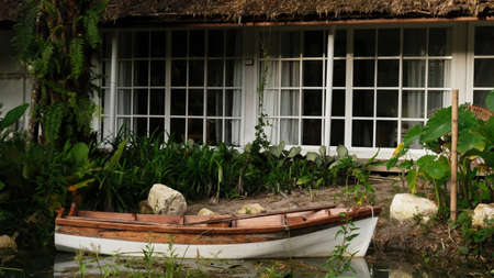 Landscape view of house and wooden boat in Thailand.の写真素材