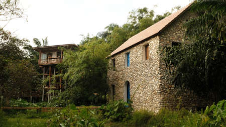 English traditional stone cottage and wooden house with warm light.の写真素材