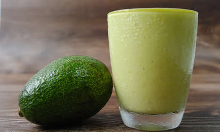 Selective focus fresh avocado smoothie blend with yogurt, milk and honey, healthy drink concept.の写真素材