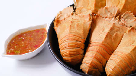 Big steamed crawfish (crayfish)  in a dish with spicy sauce isolated on white background.の写真素材