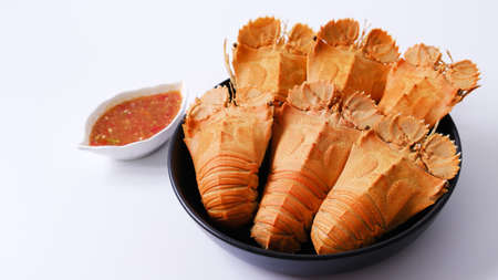 Big steamed crawfish (crayfish)  in a dish with spicy sauce isolated on white background.の写真素材