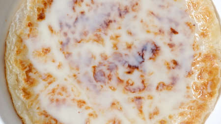 Chapati a thin pancake known as roti topping with sweet condense milk, Indian traditional street...