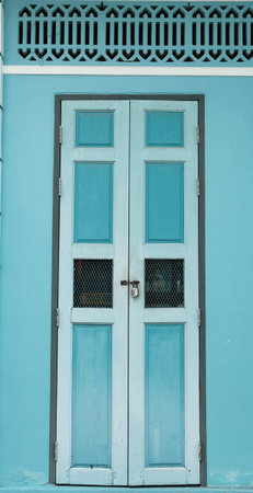 House with a retro blue wooden door, Chinese style.の写真素材