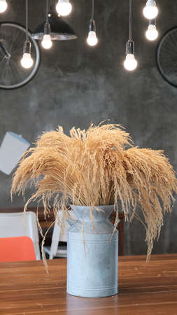 Bunch of dried barley rice flower in  aluminium can decoration on table.の写真素材
