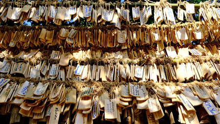 January-01-2022 : Ratchaburi, Thailand : selective focus on wooden hanging sign praying with Thai...
