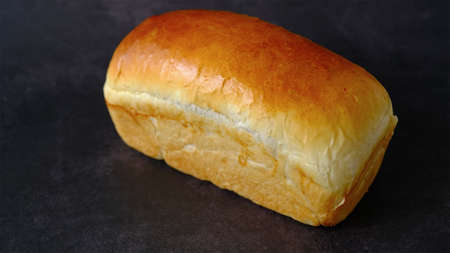 Top view loaf of bread isolated on black background.