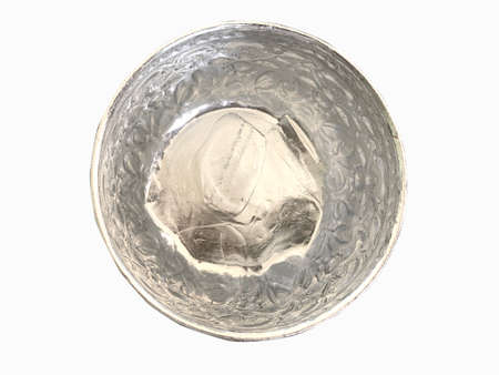 Top view ice water in traditional Thai silver bowl isolated on white background.の写真素材