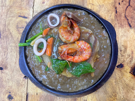 Seafood noodle with gravy sauce in sizzing  plate (Rad Nah noodle)の写真素材
