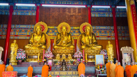 January 22 2023 - Nonthaburi, Thailand : Chinese monks praying in front of the golden statue at Wat Boromracha Kanchanapisek Anusorn (or Wat Leng Noei Yi 2).のeditorial素材