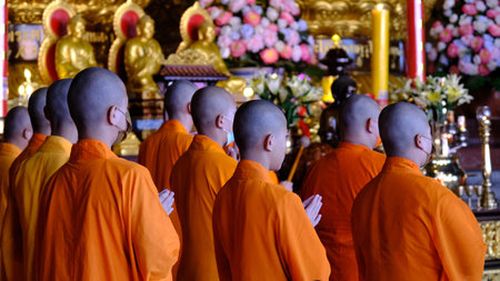 January 22 2023 - Nonthaburi, Thailand : Chinese monks praying in front of the golden statue at Wat Boromracha Kanchanapisek Anusorn (or Wat Leng Noei Yi 2).のeditorial素材