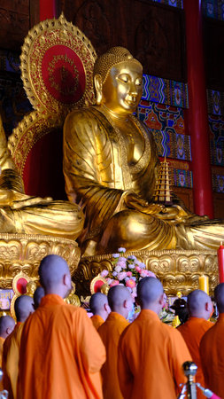 January 22 2023 - Nonthaburi, Thailand : Chinese monks praying in front of the golden statue at Wat Boromracha Kanchanapisek Anusorn (or Wat Leng Noei Yi 2).のeditorial素材