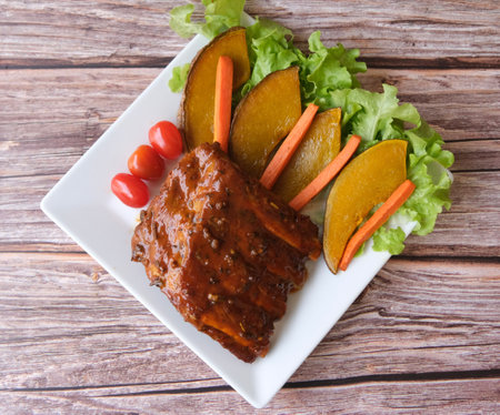 Table top view grilled and smoked pork ribs with on wooden board.の写真素材