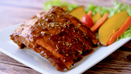 Table top view grilled and smoked pork ribs with on wooden board.の写真素材