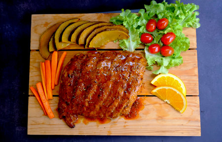 Table top view grilled and smoked pork ribs with on wooden board.の写真素材