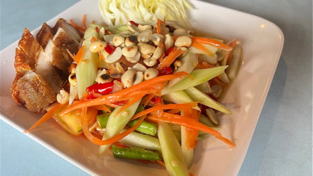 Spicy Chinese Broccoli with deep fried pork belly salad.の写真素材