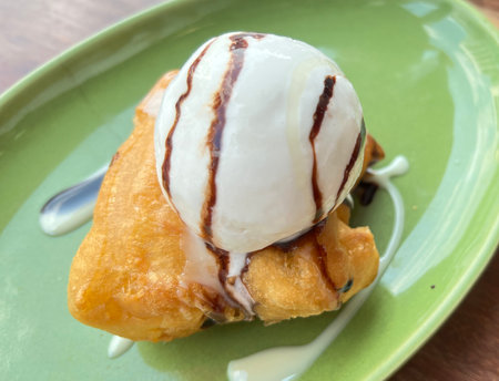 Deep-fried traditional Thai dough with ice cream on top.の写真素材