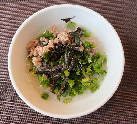 Top view ground pork Congee or Porridge with pork, dried seaweed and vegetables.の写真素材