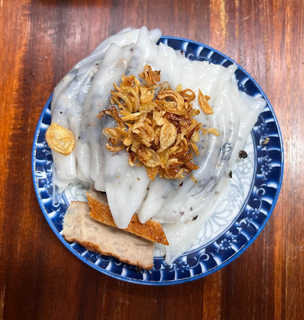 Streamed rice rolls with baked fat pork paste and fried garlic on top, Vietnamese food.の写真素材