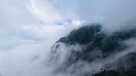 Spectacular view top of mountain surrounded with clouds. Amazing peak in clouds.の写真素材