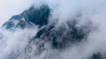 Spectacular view top of mountain surrounded with clouds. Amazing peak in clouds.の写真素材