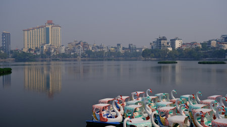 November 18 2022 - Hanoi, Vietnam : Swan paddle boats in the lake ready to serve.のeditorial素材