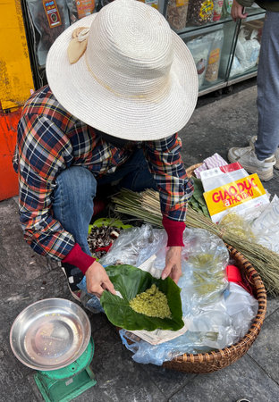 November 18 2022 - Hanoi, Vietnam : Vendor selling food on street in Hanoi city.のeditorial素材