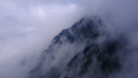 Spectacular view top of mountain surrounded with clouds. Amazing peak in clouds.の写真素材