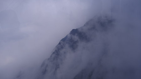 Spectacular view top of mountain surrounded with clouds. Amazing peak in clouds.の写真素材
