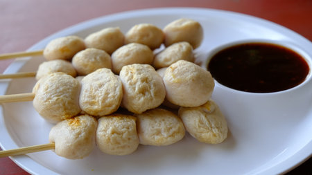 Grilled meatball skewer ( pork ball) with sauce on the side, Thai popular street food.の写真素材