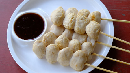 Grilled meatball skewer ( pork ball) with sauce on the side, Thai popular street food.の写真素材